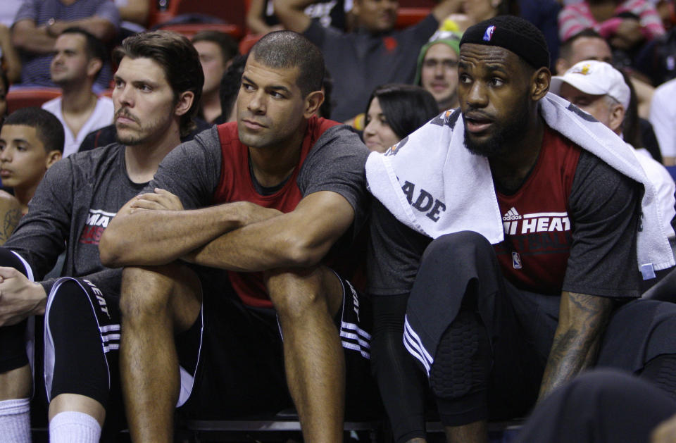 FILE - Miami Heat's Mike Miller, left, Shane Battier, center, and LeBron James, right, watch from the bench during a Miami Heat NBA basketball scrimmage on Thursday, Dec. 15, 2011, in Miami. Former Heat forward Battier, in an essay for The Associated Press, says he would sometimes marvel at the things James did when they were teammates. James is about to pass Kareem Abdul-Jabbar for the NBA career scoring record. (AP Photo/Lynne Sladky, File)