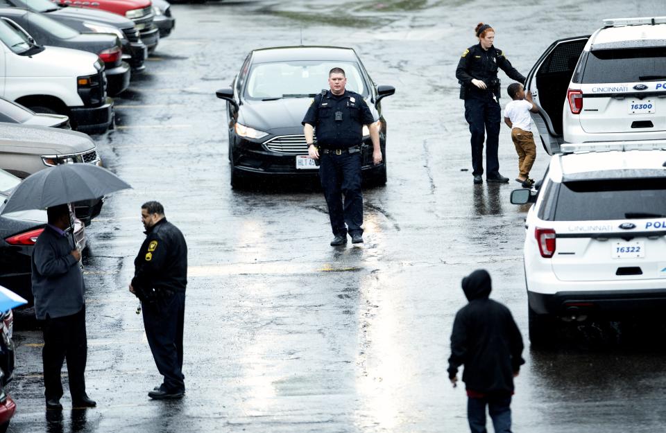 A Cincinnati police officer helps Kayden Allen, then 5, into a cruiser after his mom, Patricia Woods, was killed in their apartment at the Renata Apartments on the 2400 Block of Westwood Northern Boulevard on Friday, April 17, 2020 in Westwood. Her daughter, Kay-Lia McCree, then 14 months, was also in the home. Her boyfriend, Marcus Reed has been charged with aggravated murder. His trial is set for November 2021. 