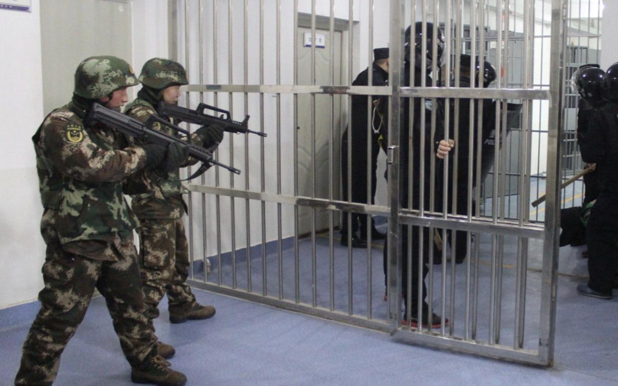 Officials stand guard in an internment camp in Xinjiang - Adrian Zenz