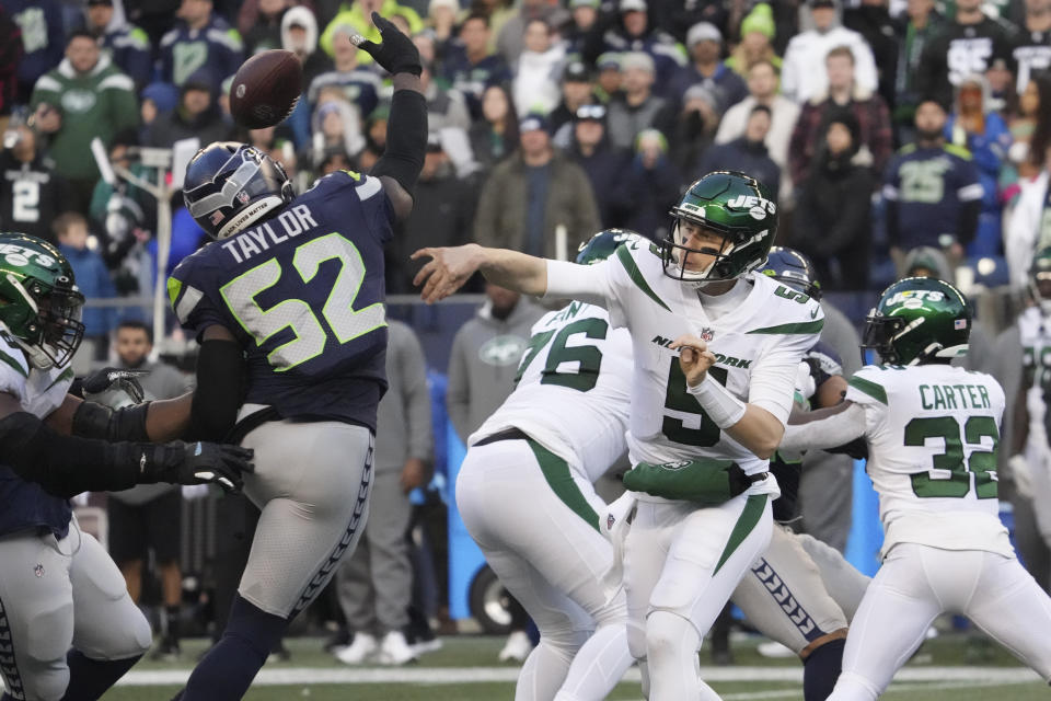 New York Jets quarterback Mike White (5) throws under pressure from Seattle Seahawks defensive end Darrell Taylor (52) during the second half of an NFL football game, Sunday, Jan. 1, 2023, in Seattle. The Seahawks defeated the Jets 23-6. (AP Photo/Ted S. Warren)