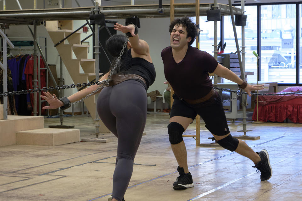 Actors Krystina Alabado, left, and Joel Perez rehearse a scene from the musical comedy “Kiss My Aztec!” in Hartford, Conn., on May 12, 2022. The show, co-written by John Leguizamo and director Tony Taccone, will play at the Hartford Stage from June 1 to June 26. (Alan Arias via AP)