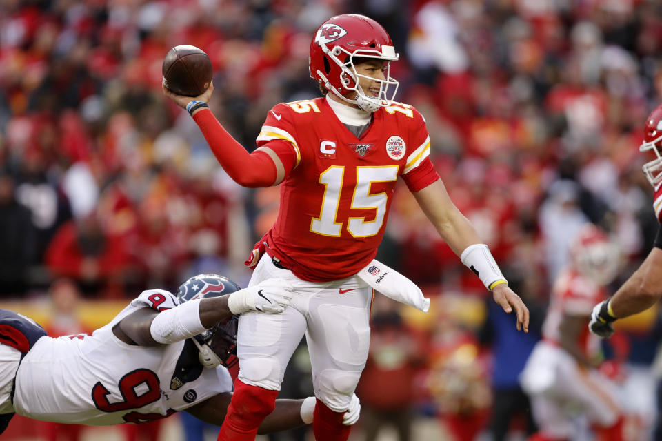 Kansas City Chiefs quarterback Patrick Mahomes (15) throws under pressure from Houston Texans defensive end Charles Omenihu (94) during the first half of an NFL divisional playoff football game, in Kansas City, Mo., Sunday, Jan. 12, 2020. (AP Photo/Jeff Roberson)