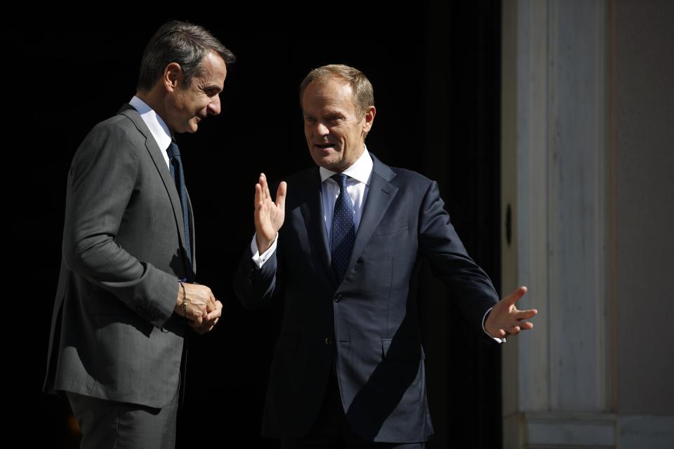 European Council President Donald Tusk, right, speaks with Greece's Prime Minister Kyriakos Mitsotakis during their metering at Maximos Mansion in Athens, Wednesday, Oct. 9, 2019. EU leaders have demanded more "realism" from Britain in response to a Brexit plan proposed by British Prime Minister Boris Johnson. (AP Photo/Thanassis Stavrakis)