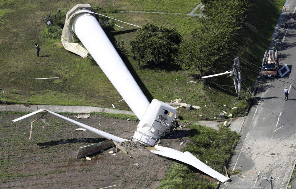 A windmill tumbles down at Hokudan Earthquake Memorial Park after Typhoon Cimarron hit Awaji, Hyogo prefecture, western Japan, Friday, Aug. 24, 2018. Typhoon Cimarron was back at sea and heading for northern Japan after crossing a swath of the western part of the country overnight, bringing heavy rain and high winds. (Kyodo News via AP)