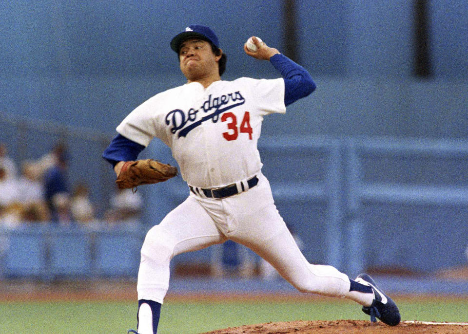 FILE - Los Angeles Dodgers pitcher Fernando Valenzuela prepares to release the ball in the first inning of the opening game of the National League Championship series against the St. Louis Cardinals, Oct. 9, 1985, in Los Angeles. The Dodgers will retire the No. 34 jersey of Valenzuela during a three-day celebration this summer. (AP Photo/Lennox McLendon, File)