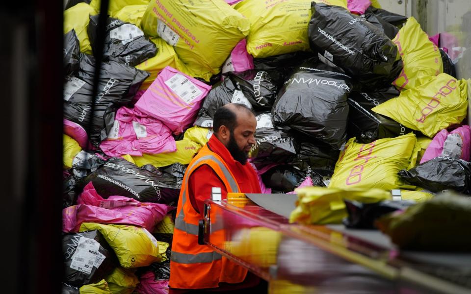 A worker at Royal Mail's parcel super hub in Warrington in Cheshire