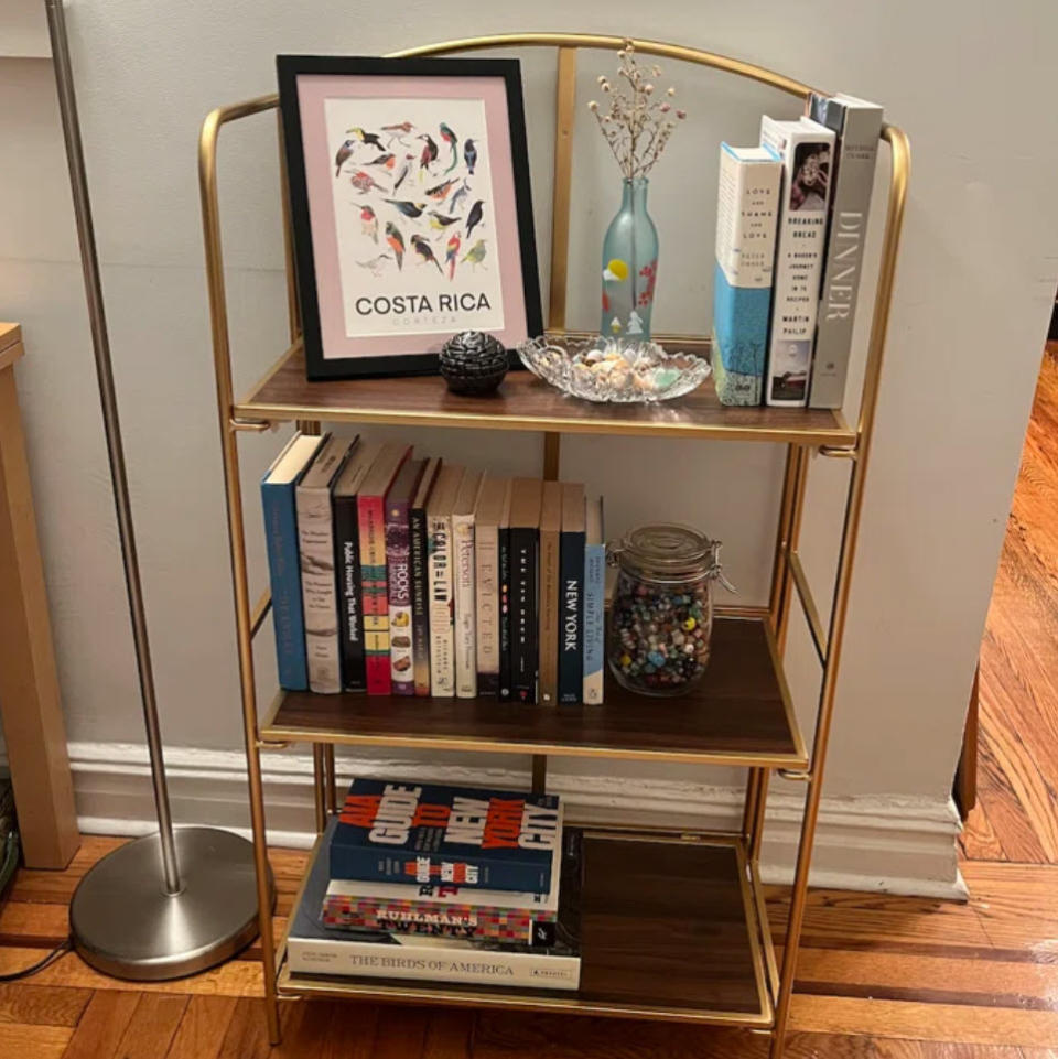 three tiered bookshelf with curved top edges