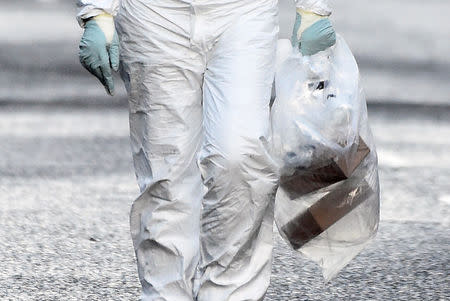 A forensic officer carries a bag of evidence from the scene of a suspected car bomb in Londonderry, Northern Ireland January 20, 2019. REUTERS/Clodagh Kilcoyne