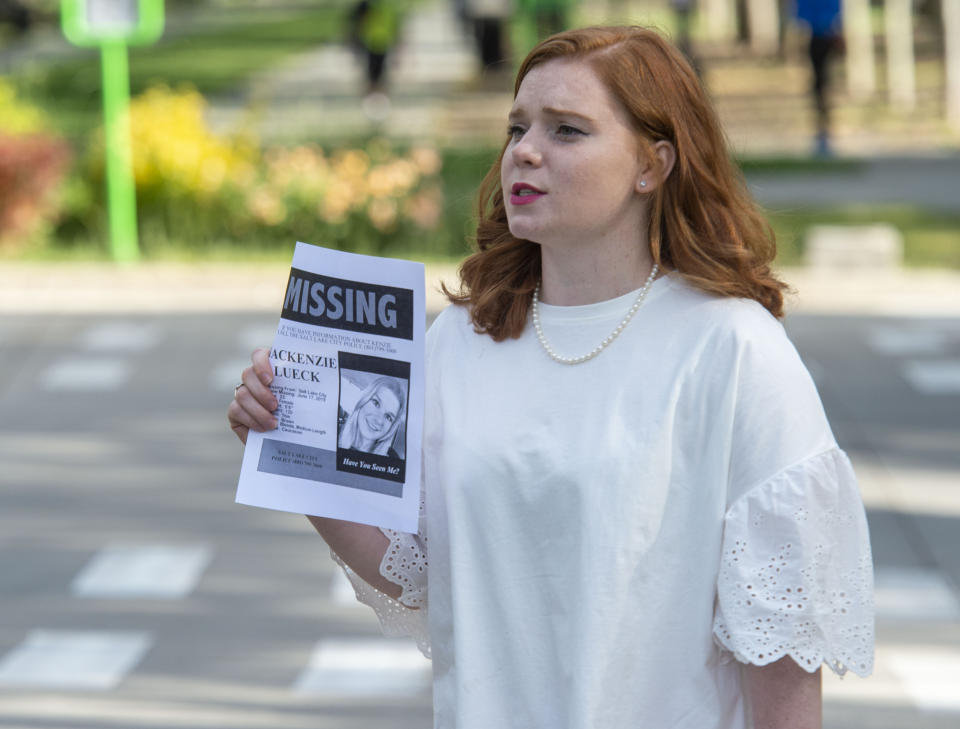 In this Saturday, June 22, 2019 photo, Ashley Fine stops motorists in Liberty Park in Salt Lake City, as she hands out flyers with Mackenzie Lueck's photo on it. Police and friends are investigating the disappearance of the 23-year-old University of Utah student, whose last communication with her family said she arrived at Salt Lake City International Airport on Monday, June 17. (Rick Egan/The Salt Lake Tribune via AP)