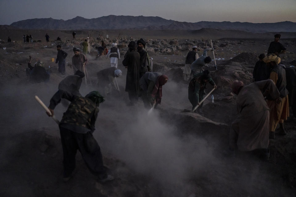 Afghans bury hundreds of people killed in an earthquake at a burial site, outside a village in Zenda Jan district in Herat province, western of Afghanistan, Monday, Oct. 9, 2023. Saturday's deadly earthquake killed and injured thousands when it leveled an untold number of homes in Herat province. (AP Photo/Ebrahim Noroozi)