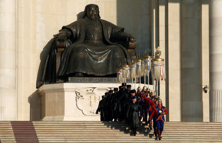 Honour guards and security personnel walk down the stairs in front of the statue of Genghis Khan at the parliament building during a ceremony marking National Pride Day, also the birthday of Genghis Khan, at Genghis Square, formerly Sukhbaatar Square, in Ulan Bator, November 23, 2014. REUTERS/B. Rentsendorj/File Photo