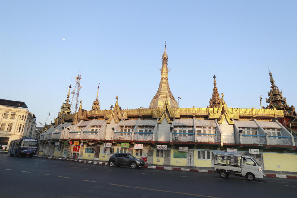 Vehicles are driven past the Sule Pagoda Monday, Feb. 1, 2021 in Yangon, Myanmar. A military coup was taking place in Myanmar early Monday and State Counsellor Aung San Suu Kyi was detained under house arrest, reports said, as communications were cut to the capital. (AP Photo/Thein Zaw)