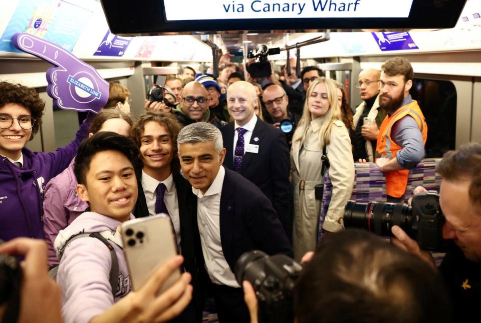 Mayor of London Sadiq Khan poses for a selfie on the day the Elizabeth Line opened to members of the public in May 2022 (REUTERS)