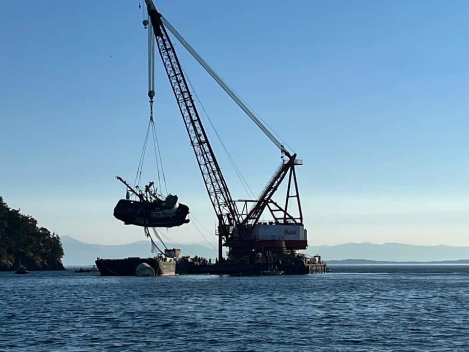 A crane pulls the Aleutian Isle onto a salvage barge off of Washington state's San Juan Island on Wednesday, Sept. 21. (Amy Liz Trainer - image credit)