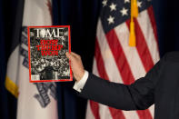 <p>Presumptive Republican presidential candidate Donald Trump holds his Time cover during a rally, Jan. 12, 2016, in Cedar Falls, Iowa. <i>(Photo: Jae C. Hong/AP)</i> </p>