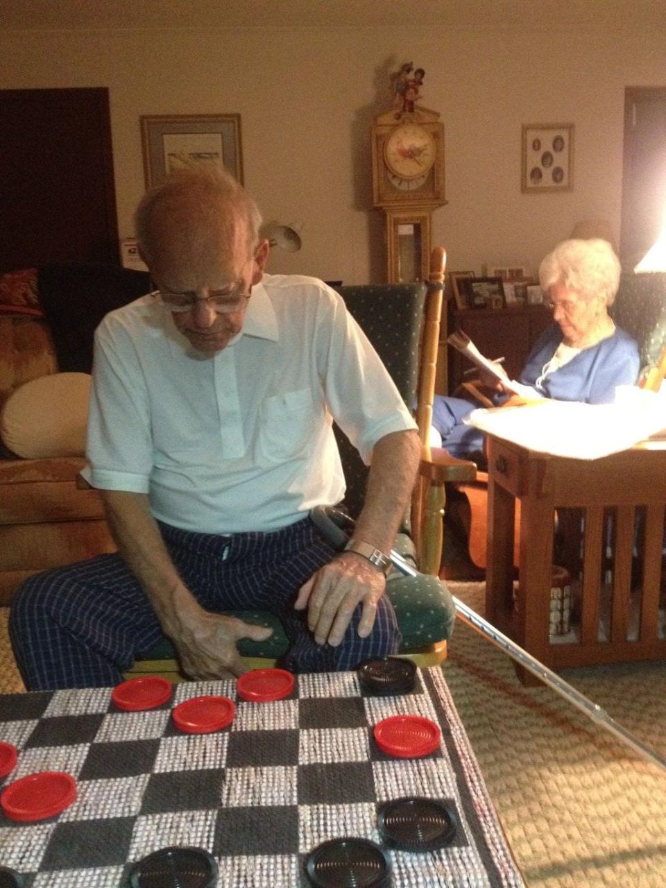 Candace's Dad considers his next move at checkers.