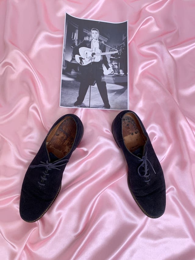 Elvis Presley’s blue suede shoes and black and white photograph of Elvis performing