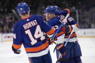 New York Islanders' Casey Cizikas (53) celebrates his goal against the Pittsburgh Penguins with Bo Horvat (14) and Alexander Romanov during the second period of an NHL hockey game against the Pittsburgh Penguins, Wednesday, April 17, 2024, in Elmont, N.Y. (AP Photo/Seth Wenig)