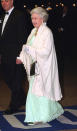 <p>Her Majesty dressed in a festive green dress complete with metallic accessories back in the year 2000. (Getty Images)</p> 