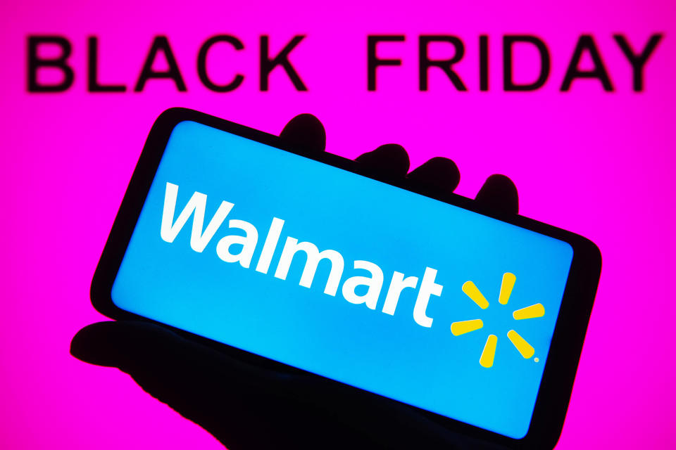 black friday text in black on pink background walmart on phone