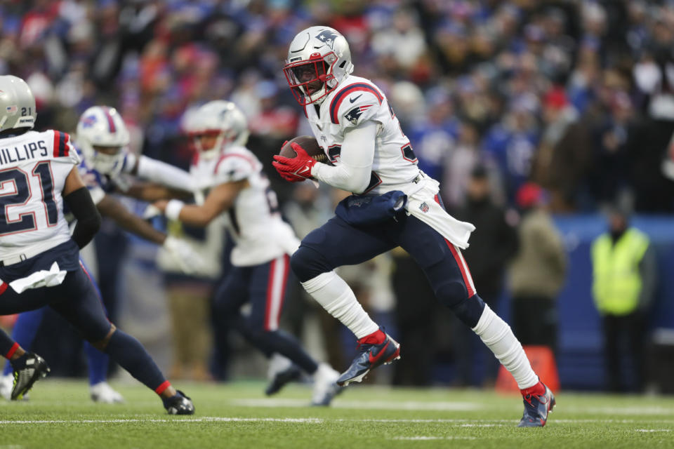 FILE - New England Patriots safety Devin McCourty (32) returns an interception during the first half of an NFL football game against the Buffalo Bills on Sunday, Jan. 8, 2023, in Orchard Park, N.Y. McCourty is retiring from the NFL, ending a 13-year run with the team that included winning three Super Bowl rings.(AP Photo/Joshua Bessex, File)