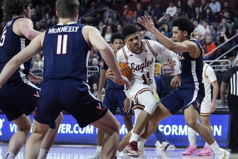 Boston College guard Makai Ashton-Langford (11) drive to the basket through Virginia defenders during the second half of an NCAA college basketball game, Wednesday, Feb. 22, 2023, in Boston. (AP Photo/Charles Krupa)