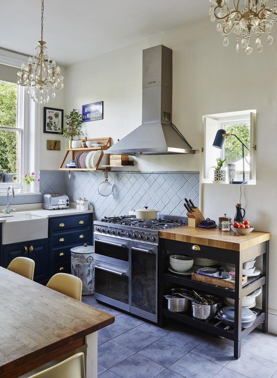 navy blue and white kitchen with chandelier