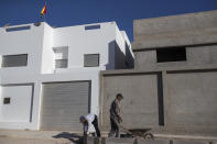 Construction men at work in a neighborhood containing recently opened consulates in Dakhla, Western Sahara, Monday, Dec. 21, 2020. .S. plans to open a consulate in Western Sahara mark a turning point for the disputed and closely policed territory. U.S. recognition of Morocco’s authority over the land frustrates indigenous Sahrawis seeking independence. But others see the future U.S. consulate as a major boost for Western Sahara cities like Dakhla. (AP Photo/Mosa'ab Elshamy)