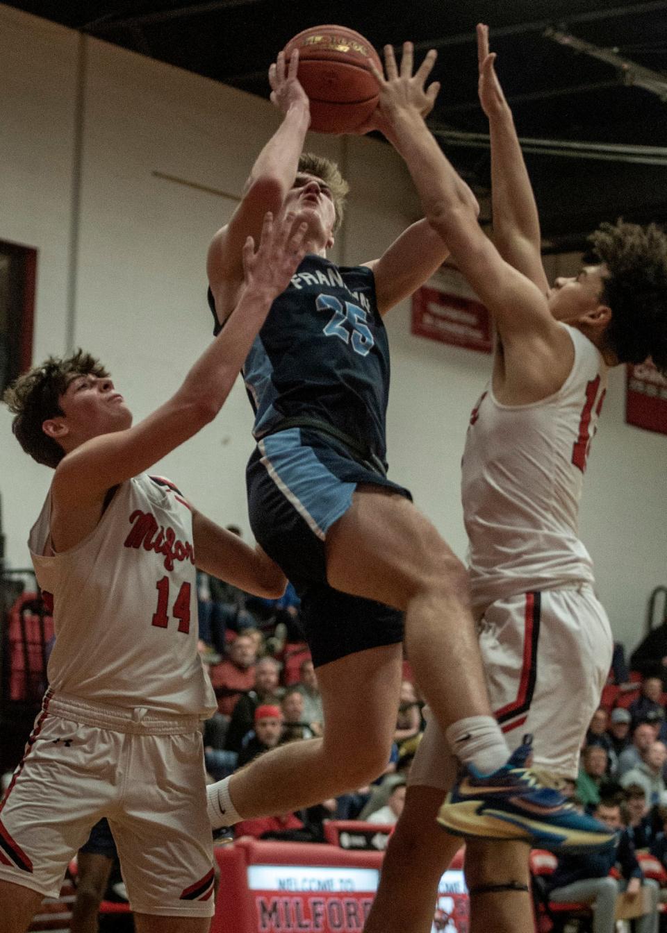 Franklin High School junior Sean O'Leary heads to the basket against Milford, Feb. 17, 2023.