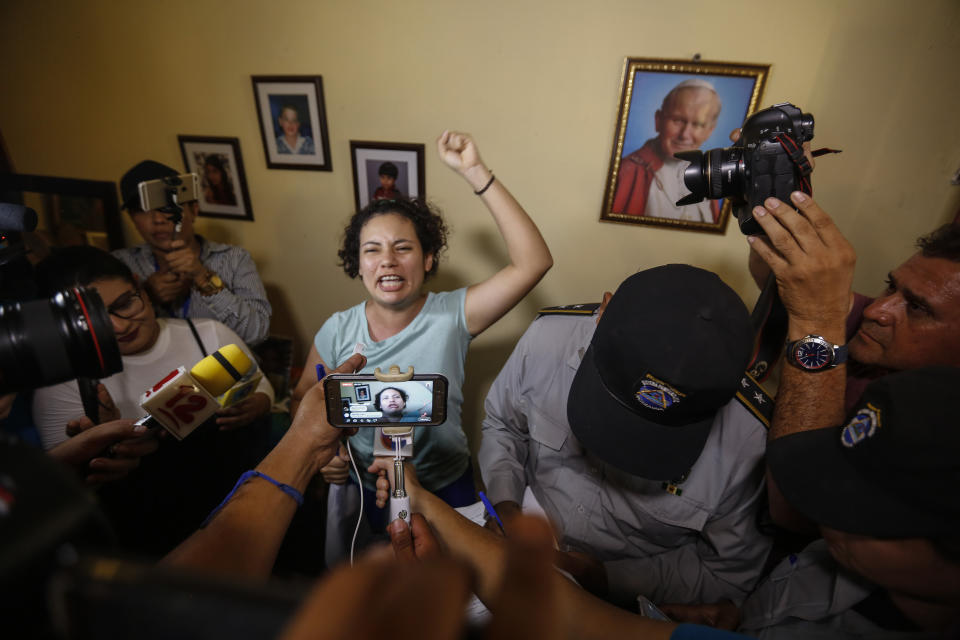 Opposition member María Adilia Peralta Cerratos raises her fist in defiance as she talks to the press during her return home after being in prison, in Masaya, Nicaragua, Monday, May 20, 2019. Peralta Cerratos is one of 100 prisoners the Nicaraguan government released Monday in a form of house arrest, including three human rights activists. (AP Photo/Alfredo Zuniga)