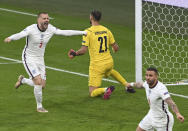 England's Luke Shaw, left, celebrates after scoring his side's opening goal during the Euro 2020 final soccer match between Italy and England at Wembley stadium in London, Sunday, July 11, 2021. (Facundo Arrizabalaga/Pool via AP)