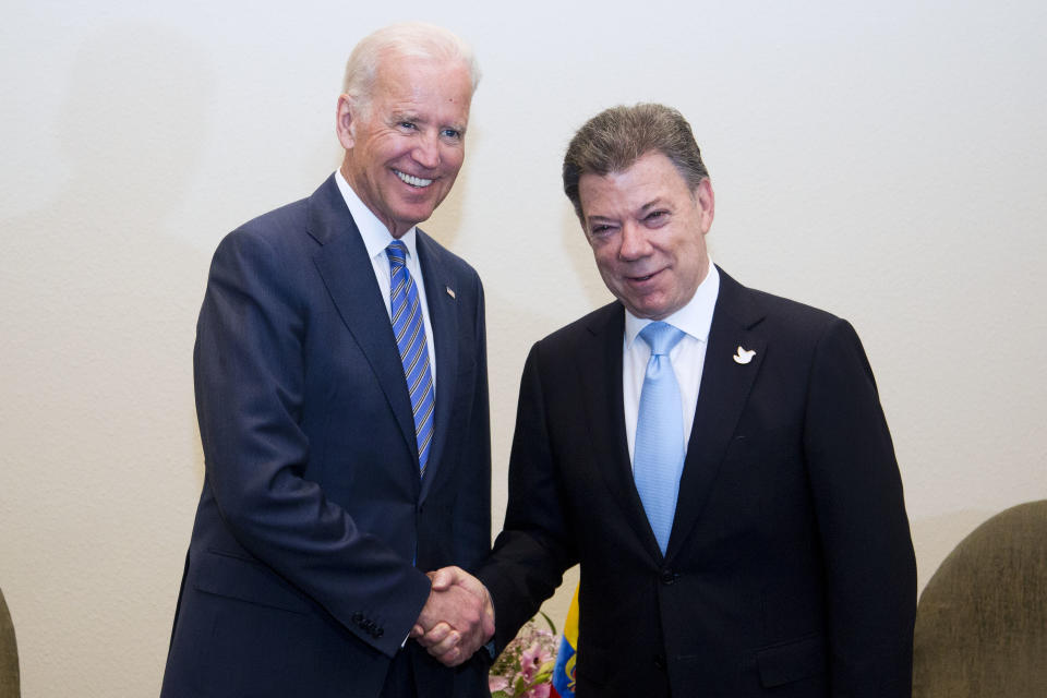 Vice President Joe Biden, right, and Colombia's President Juan Manuel Santos pose for a photo before their bilateral meeting at a hotel in Santiago, Chile, Tuesday, March 11, 2014. (AP Photo/Victor R. Caivano)