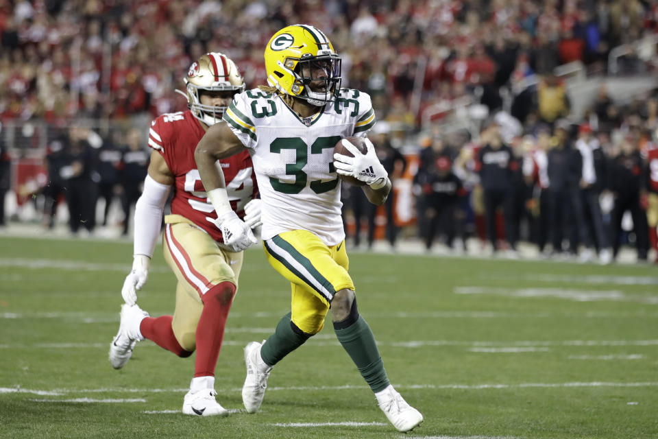 Green Bay Packers running back Aaron Jones (33) runs for a touchdown in front of San Francisco 49ers defensive end Solomon Thomas during the second half of the NFL NFC Championship football game Sunday, Jan. 19, 2020, in Santa Clara, Calif. (AP Photo/Ben Margot)