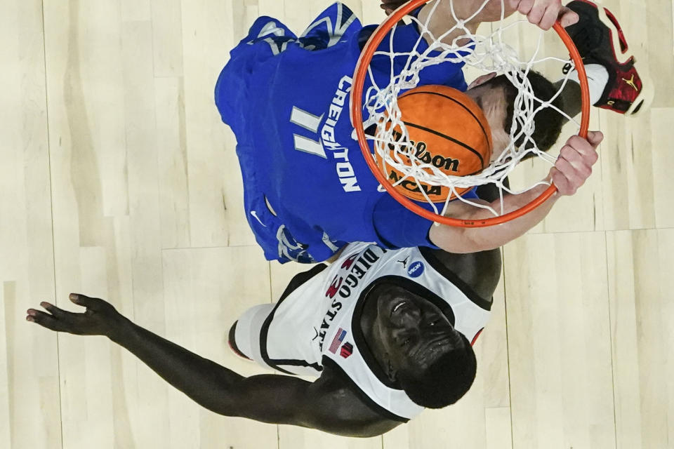 Creighton center Ryan Kalkbrenner (11) dunks the ball against San Diego State forward Aguek Arop (33) in the second half of a Elite 8 college basketball game in the South Regional of the NCAA Tournament, Sunday, March 26, 2023, in Louisville, Ky. (AP Photo/John Bazemore)