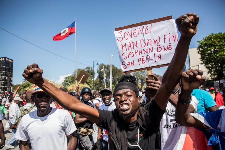 Demonstrators march in Port-au-Prince on February 14, 2021, to protest against the government of President Jovenel Moise. - Several thousand people demonstrated on February 14, 2021 to denounce a new dictatorship in Haiti and the international community’s support for President Jovenel Moise. The protesters were accusing Moise of illegally extending his term. He says it lasts until February 2022 -- but the opposition argues it should have ended last weekend, in a standoff over disputed elections. (Photo by Valerie Baeriswyl / AFP) (Photo by VALERIE BAERISWYL/AFP via Getty Images)
