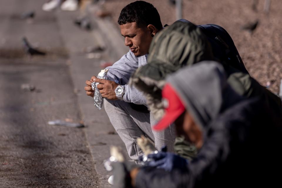 Mi Cabaña Mexican Restaurant brings juice, water, hot chocolate and burritos to Venezuelan migrants staying in the streets of El Paso in front of Sacred Heart Church, on Wednesday, Dec. 21, 2022, after crossing into the U.S.