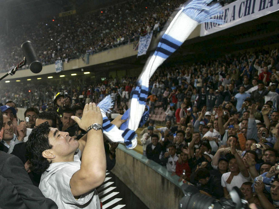 FILE - Former Argentine soccer star Diego Armando Maradona blows kisses to his fans in the San Paolo stadium in Naples, southern Italy, June 9, 2005. The legend of Diego Maradona at Napoli hovers over the current team’s Italian league title, which was sealed Thursday, May 4, 2023. The Argentina standout holds saint-like status in Naples 2 ½ years after his death and more than three decades after he led Napoli to its first two Serie A titles. (AP Photo/Salvatore Laporta, File)
