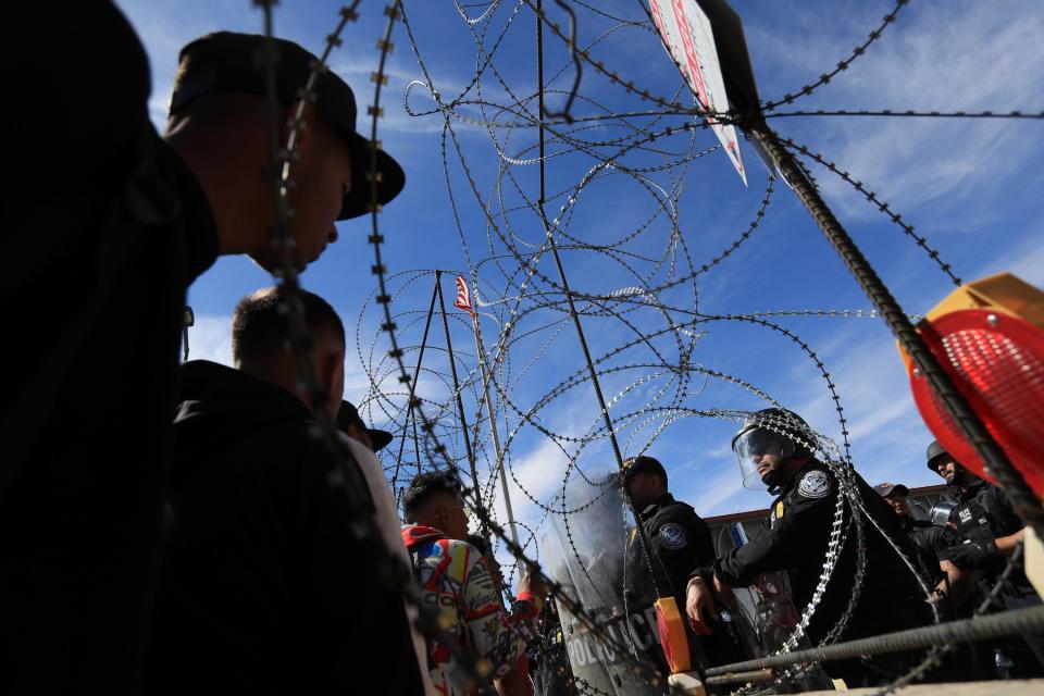 U.S. Customs and Border Protection officers guard the Paso Del Norte Bridge on Sunday after migrants walked onto the bridge wanting to enter the U.S. to seek asylum.