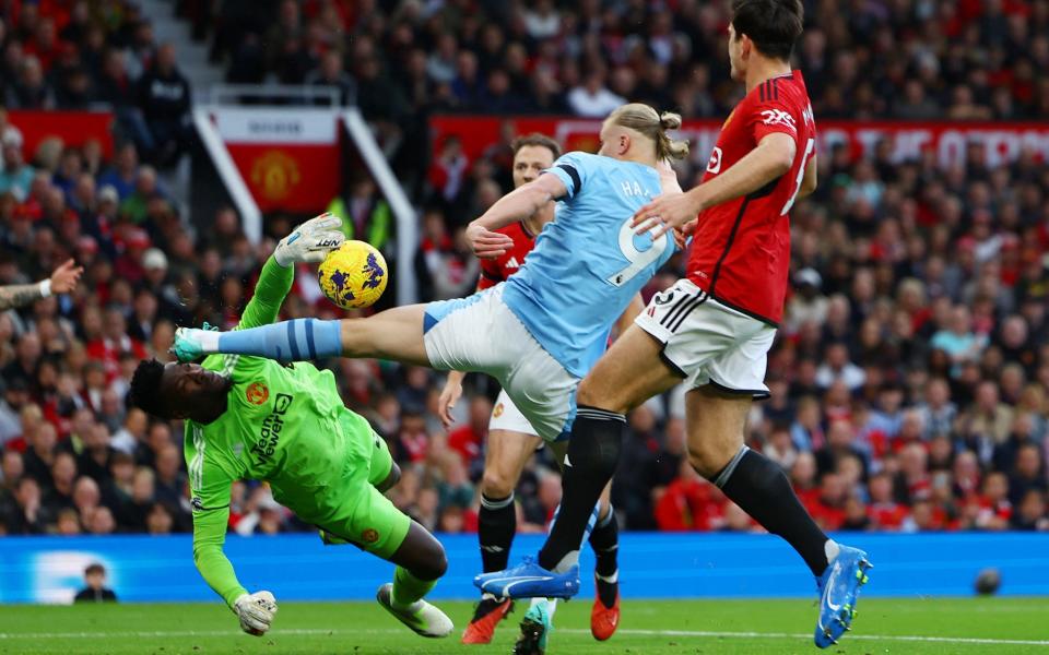 Manchester United's Andre Onana in action with Manchester City's Erling Braut Haaland