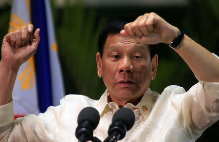 Philippine President Rodrigo Duterte gestures while answering questions during a news conference upon arrival from a trip to Myanmar and Thailand at an international airport in Manila, Philippines March 23, 2017. REUTERS/Romeo Ranoco