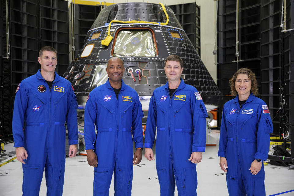 FILE - Artemis II crew members, from left, Jeremy Hansen, Victor Glover, Reid Wiseman and Christina Koch, stand together at NASA's Kennedy Space Center in Florida, in front of an Orion crew module on Tuesday, Aug. 8, 2023. On Tuesday, Jan. 9, 2024, NASA said astronauts will have to wait until 2025 before flying to the moon and another few years before landing on it. (Kim Shiflett/NASA via AP, File)