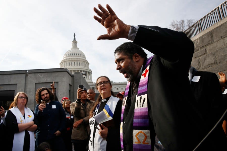 Rev. William Barber II, with the “Poor People’s Campaign,” speaks to the group after they prayed inside of the Capitol Rotunda in protest of the GOP tax overhaul, Monday, Dec. 4, 2017, on Capitol Hill in Washington. (AP Photo/Jacquelyn Martin)