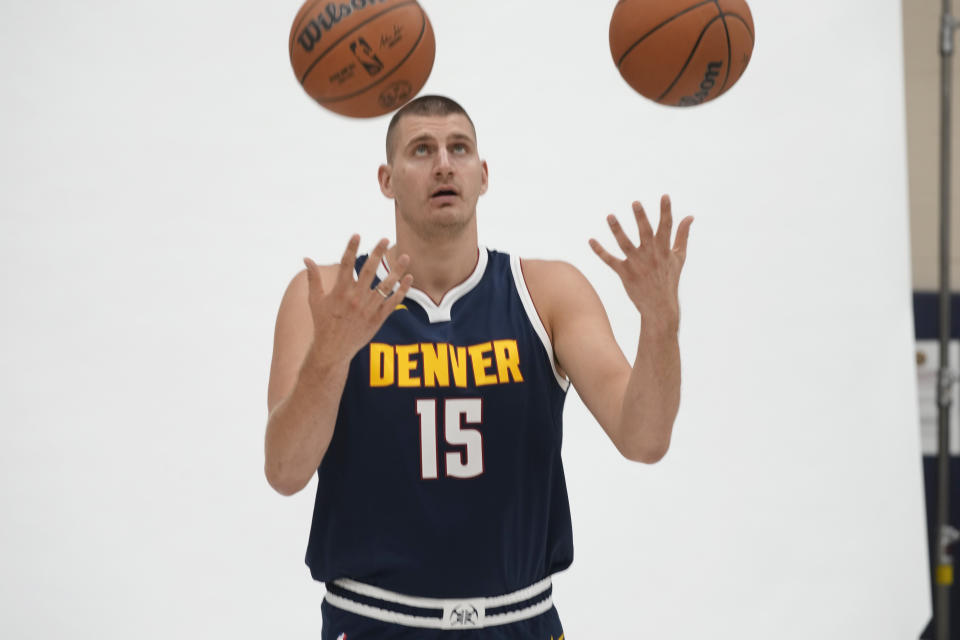 Denver Nuggets center Nikola Jokic juggles basketballs during the NBA basketball team's media day on Monday, Oct. 2, 2023, in Denver. (AP Photo/David Zalubowski)