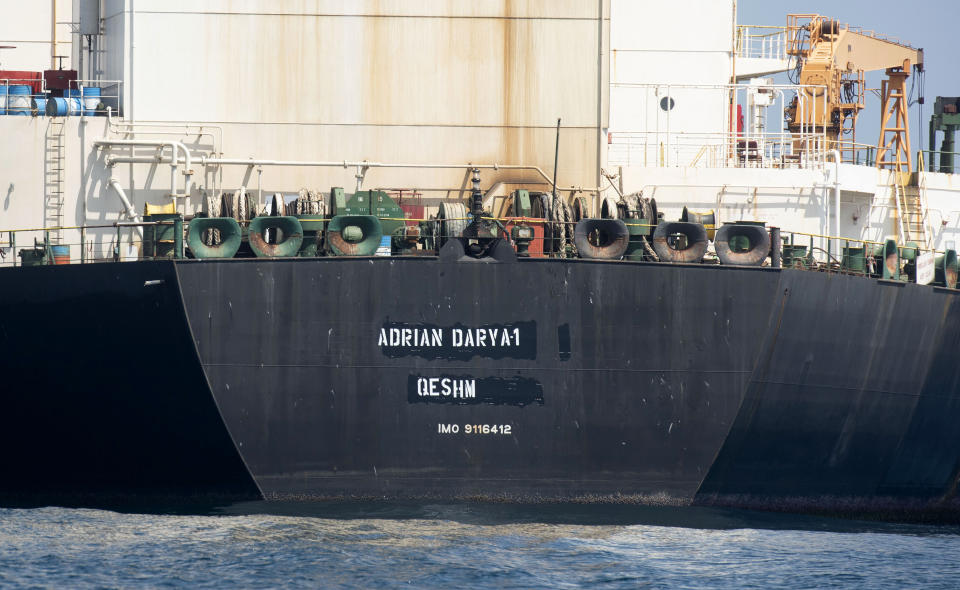 A view of the Grace 1 super tanker with the name "Adrian Darya 1" over the place where "Grace 1" had already been blackened out is seen in the British territory of Gibraltar, Saturday, Aug. 17, 2019. The shipping agent for an Iranian supertanker caught in a diplomatic standoff says the vessel is ready to depart Gibraltar in "24 to 48 hours," despite a last-minute effort by the United States to seize it again. (AP Photo/Marcos Moreno)