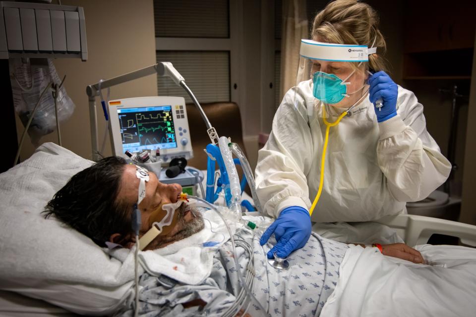 Respiratory therapist Dana Baker listens to patient Rodney Eurom's chest in the ICU at Mary Greeley Medical Center in Ames on Monday, Jan. 10, 2022.