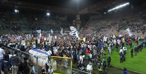 Juventus supporters celebrate on May 6, at the end of their Italian Serie A match against Cagliari at the Nereo Rocco stadium in Trieste. Juventus won the match 2-0 to win the Italian championship