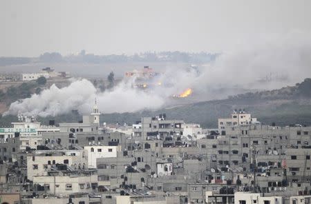 Smoke and flames are seen during Israeli offensive in the east of Gaza City July 30, 2014. REUTERS/Ahmed Zakot