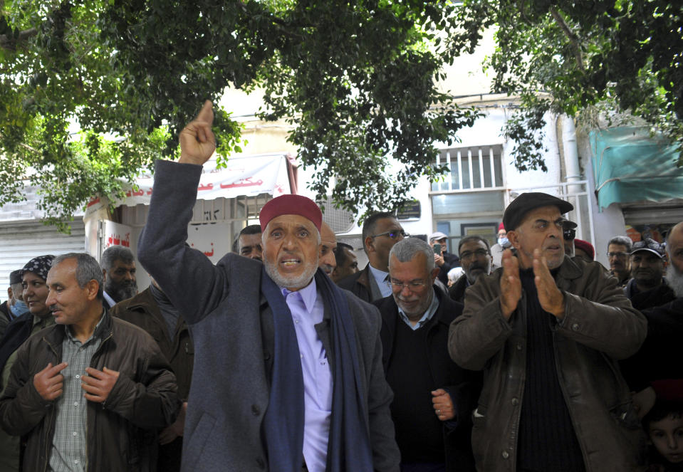 FILE - Supporters of the Tunisian Islamist movement Ennahda demonstrate Friday Dec.23, 2022 in front of the Justice Ministry in Tunis to denounce the arrest of one of its senior leaders, suspected of being involved in sending Tunisians to fight with extremists in Syria. Tunisian authorities arrested the leader of the Ennahda opposition Islamist movement Monday Feb.13, 2023 in a crackdown campaign on rival politicians and critics of the North African country's increasingly authoritarian president Kais Saied, according to lawyers. (AP Photo/Hassene Dridi, File)