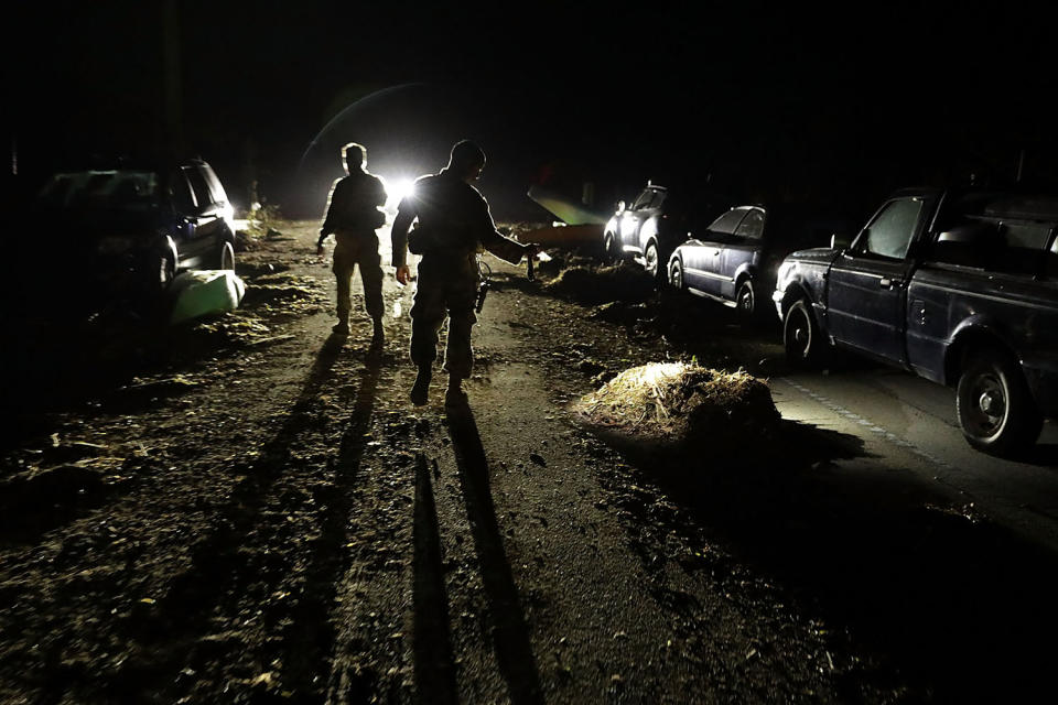 <p>Florida Army National Guard Captain Adam Cockrell and Private First Class Daniel Jimenez from Delta Company, 1st Battallion, 124th Infantry, 53rd Infantry Brigade Combat Team inspect vehicles left on a bridge connecting Big Pine Key and No Name Key two days after Hurricane Irma slammed into the state on Sept. 12, 2017 in Marathon, Florida. (Photo: Chip Somodevilla/Getty Images) </p>