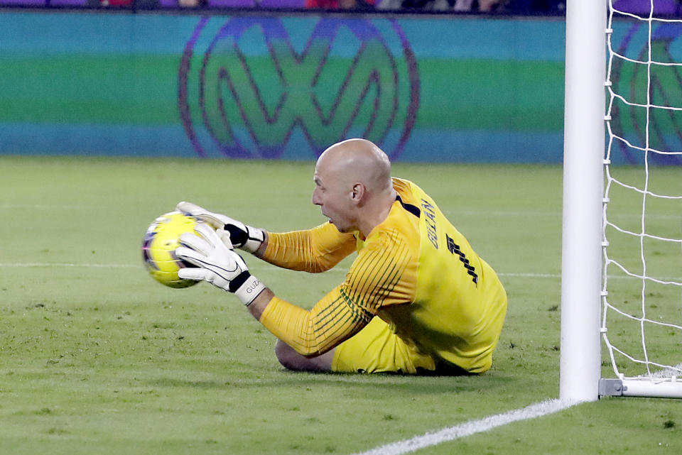 U.S. goalkeeper Brad Guzan blocks a shot during the first half of the team's CONCACAF Nations League soccer match against Canada on Friday, Nov. 15, 2019, in Orlando, Fla. (AP Photo/John Raoux)